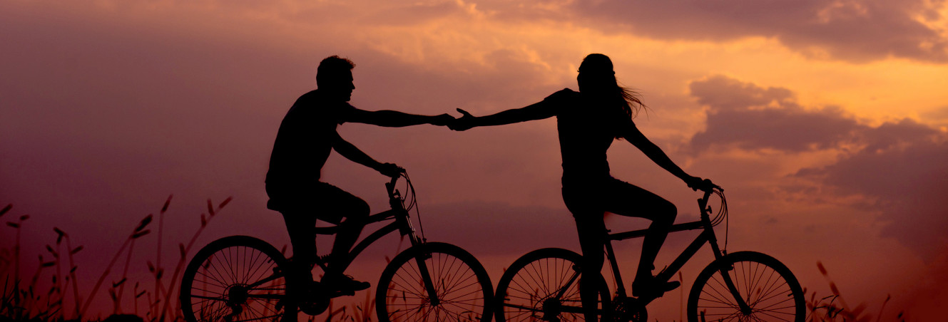 photo of people holding hands on bikes at sunset, just for the mood